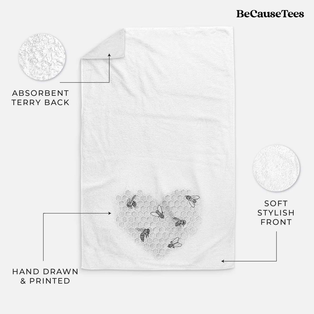 White hand towel printed with a black ink heart made of honeycomb cells with small bees crawling across it.