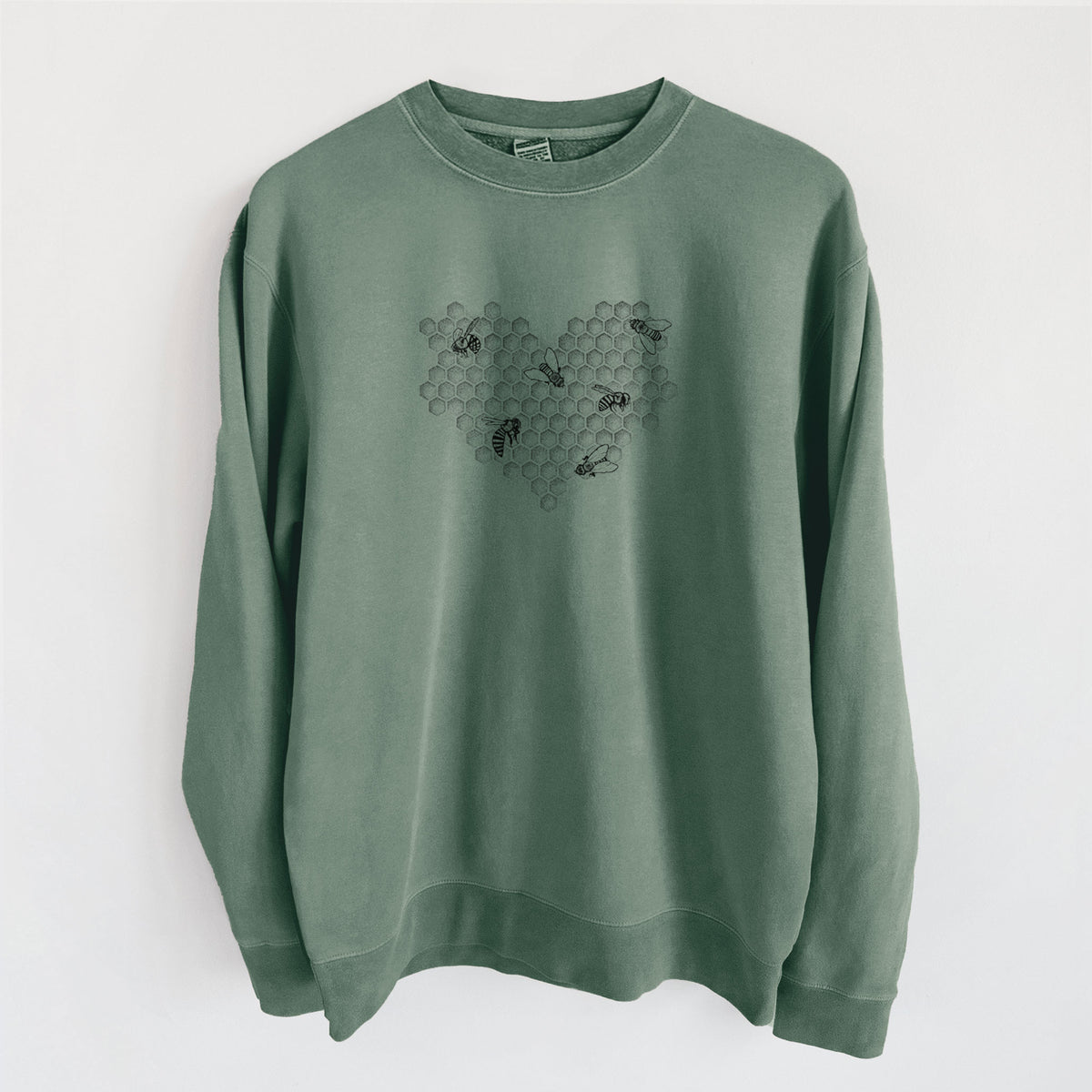 Alpine green pigment dyed crewneck sweatshirt laid flat, printed with a black ink heart made of honeycomb cells with small bees crawling across it.