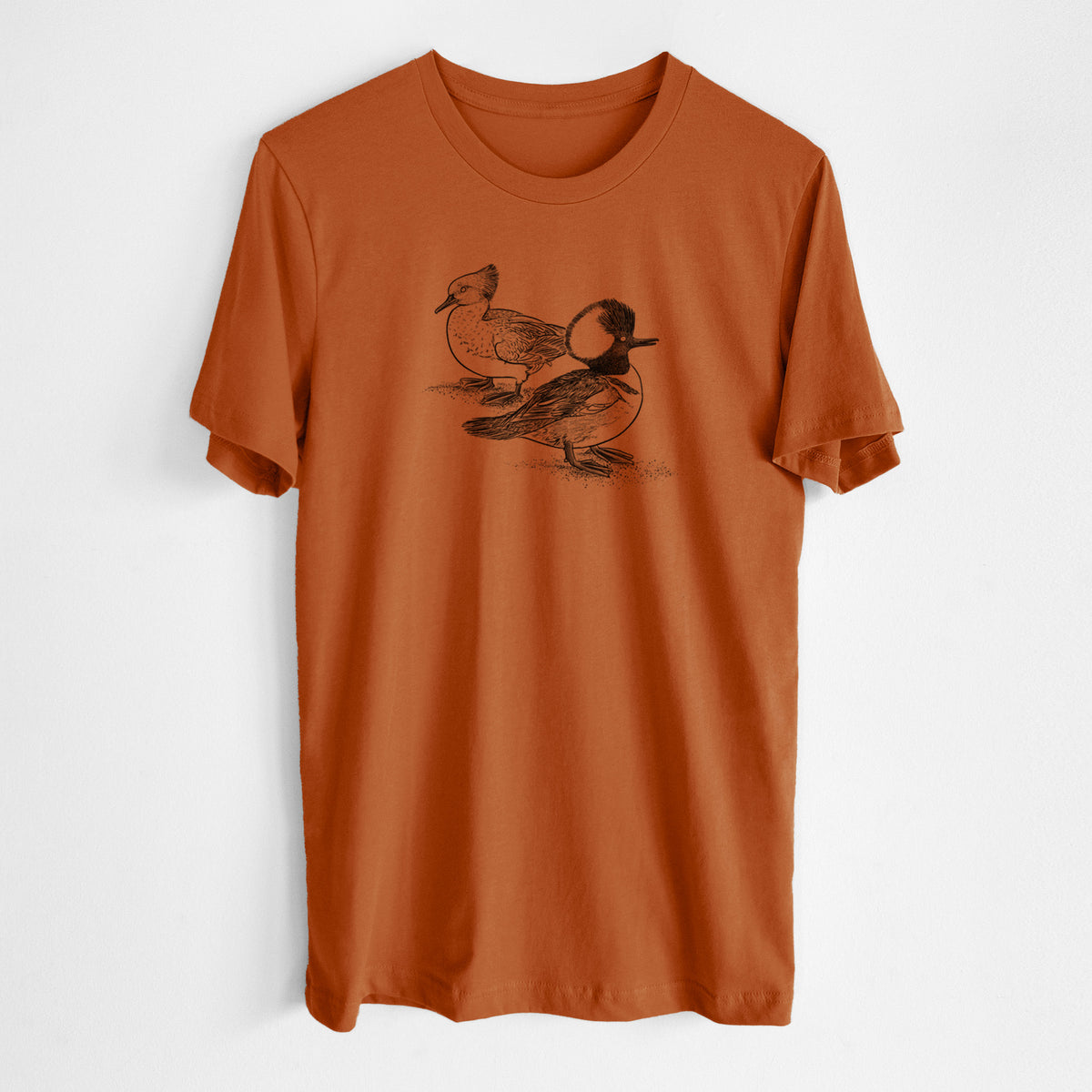 Autumn lightweight cotton t-shirt laid flat, printed with a detailed black ink illustration of a pair of hooded mergansers, male and female.