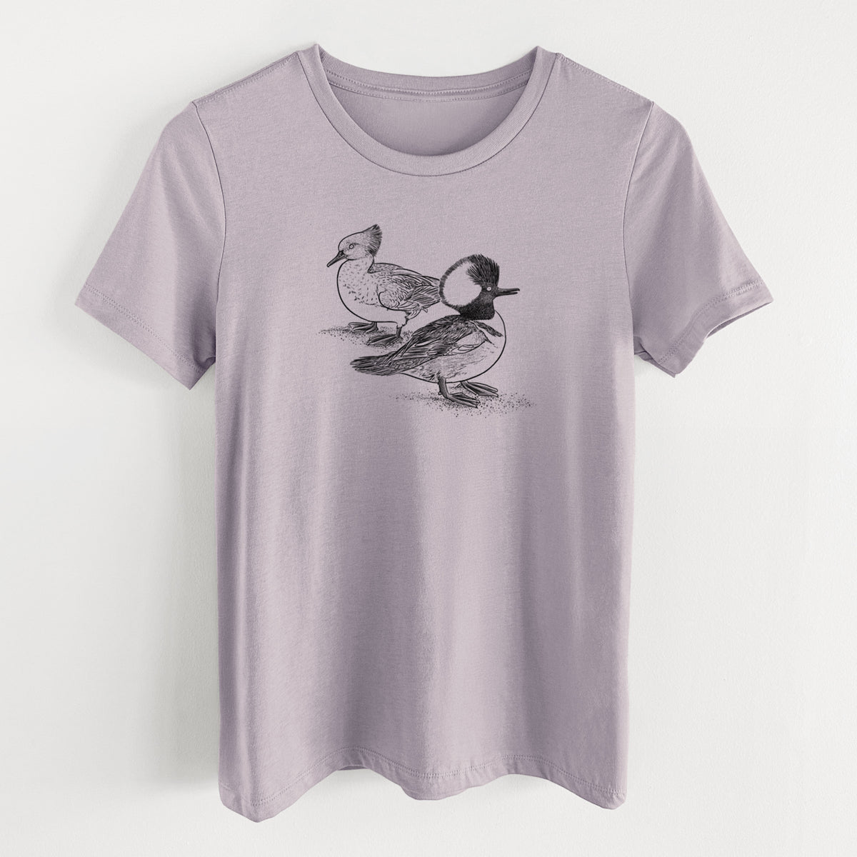 Light violet women's relaxed fit cotton t-shirt laid flat, printed with a detailed black ink illustration of a pair of hooded mergansers, male and female.