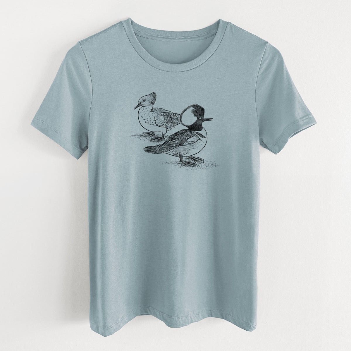 Vintage denim women's relaxed fit cotton t-shirt laid flat, printed with a detailed black ink illustration of a pair of hooded mergansers, male and female.