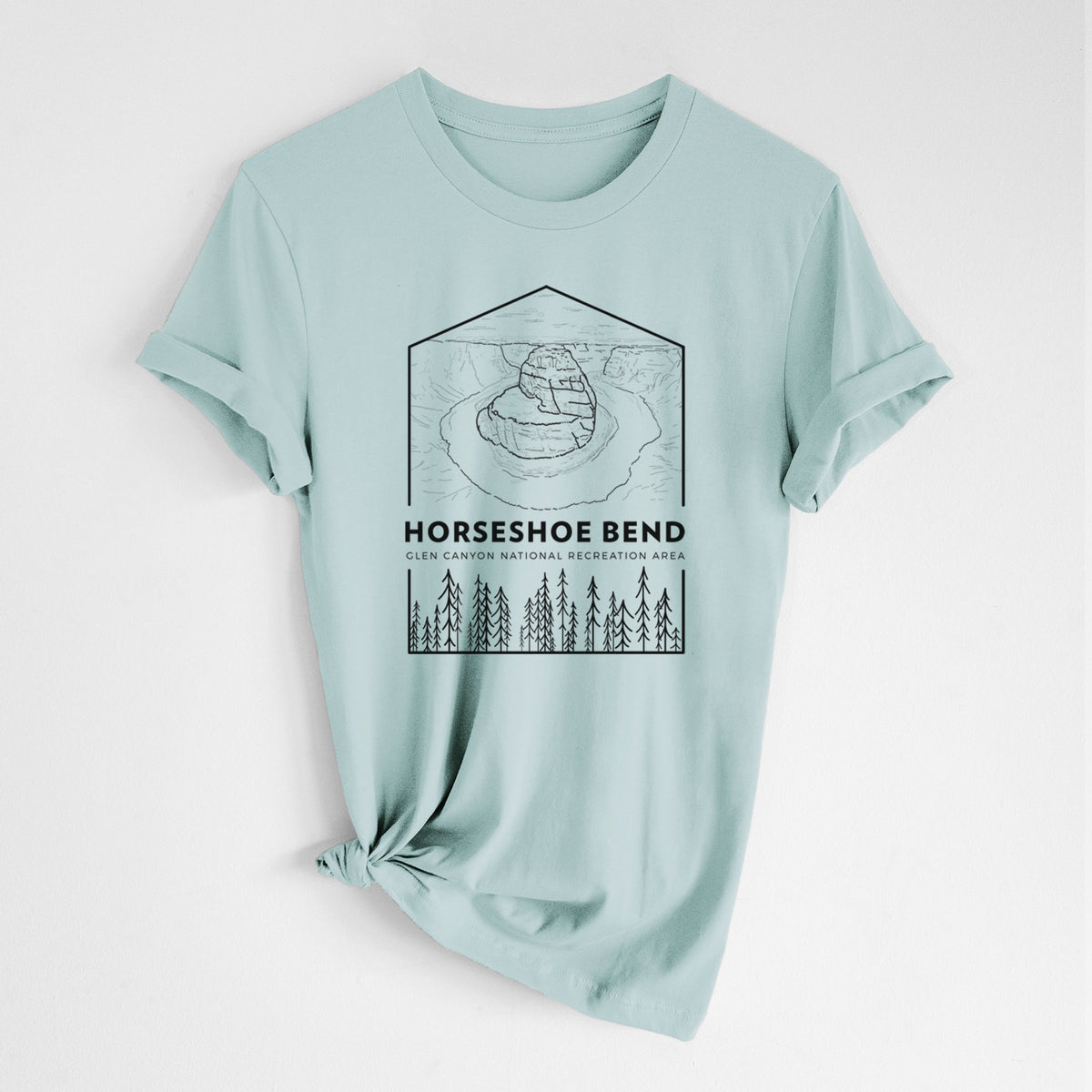 Dusty blue lightweight cotton t-shirt laid flat with the sleeves rolled, printed with a black line art badge of Horseshoe Bend above pine trees, with the words Horseshoe Bend.