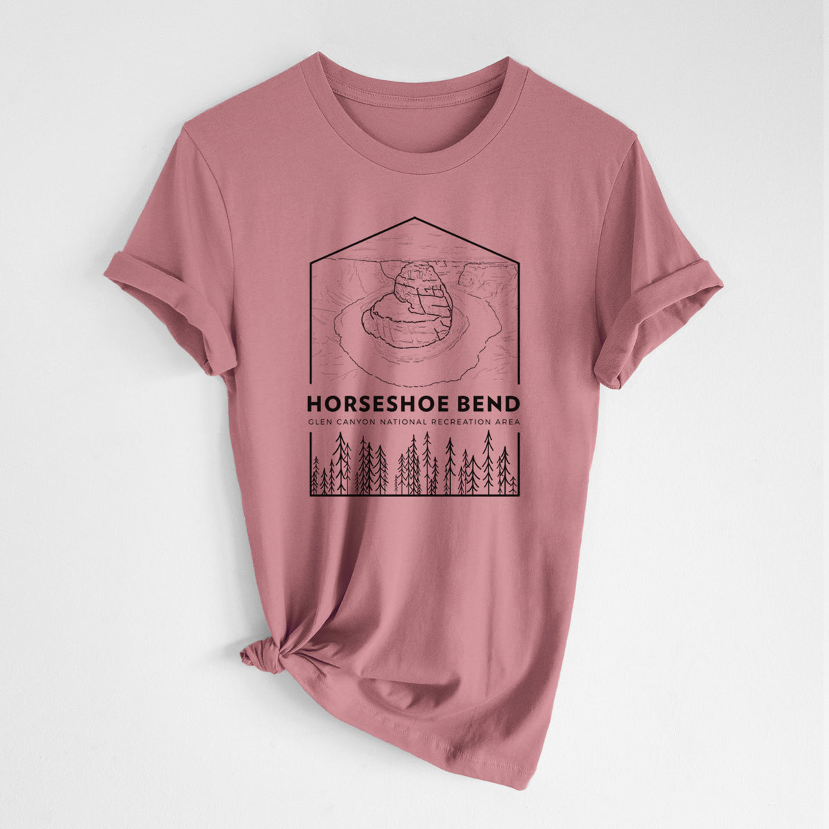 Mauve pink lightweight cotton t-shirt laid flat with the sleeves rolled, printed with a black line art badge of Horseshoe Bend above pine trees, with the words Horseshoe Bend.