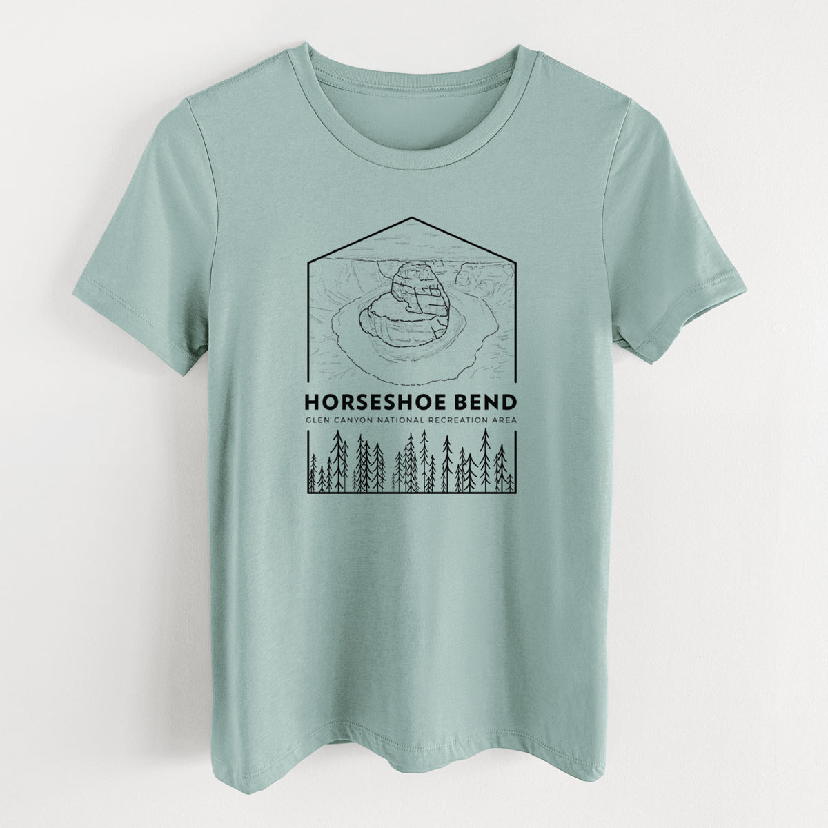 Dusty blue women's relaxed fit cotton t-shirt laid flat, printed with a black line art badge of Horseshoe Bend above pine trees, with the words Horseshoe Bend.