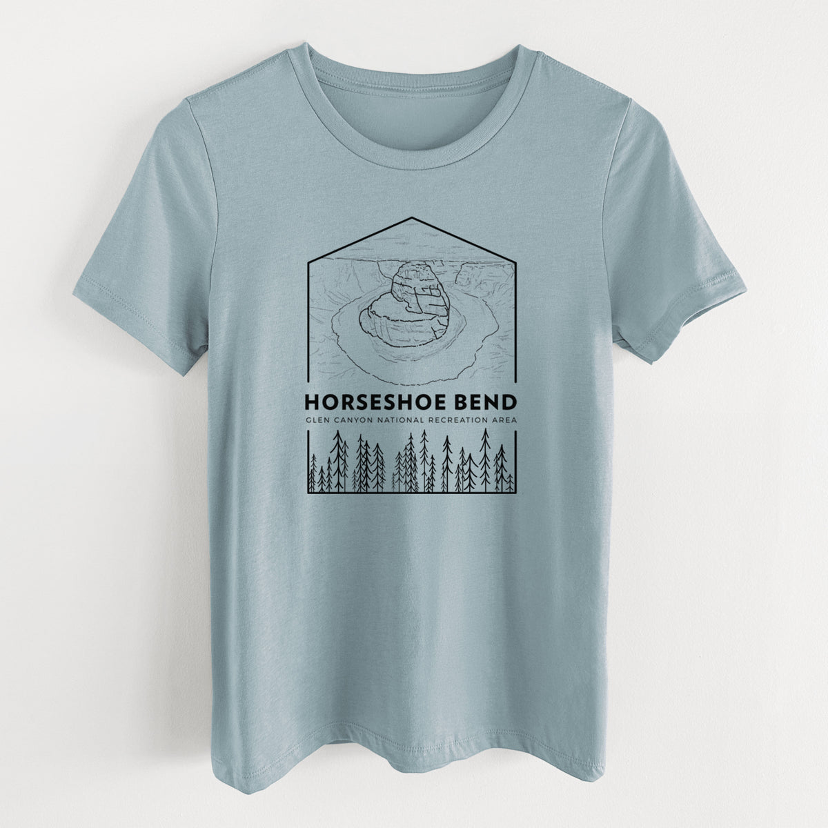 Vintage denim women's relaxed fit cotton t-shirt laid flat, printed with a black line art badge of Horseshoe Bend above pine trees, with the words Horseshoe Bend.
