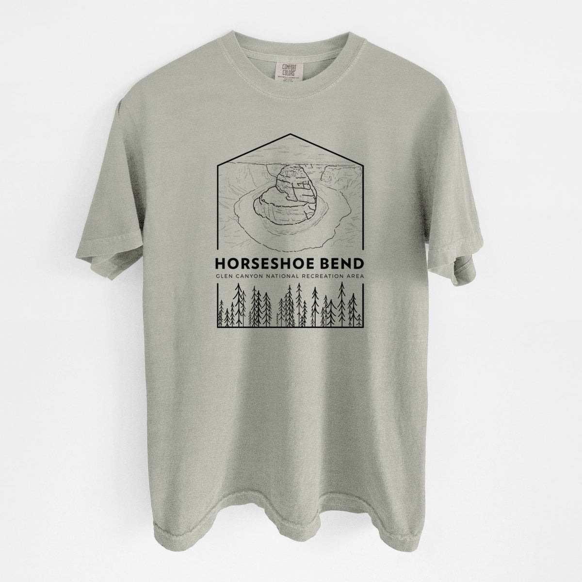 Sandstone beige Comfort Colors t-shirt laid flat, printed with a black line art badge of Horseshoe Bend above pine trees, with the words Horseshoe Bend.
