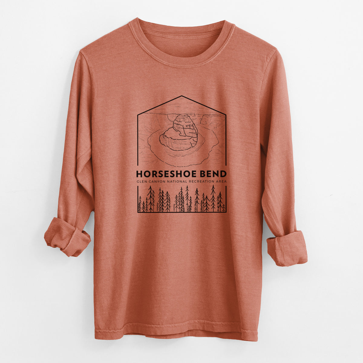 Yam burnt orange Comfort Colors long sleeve shirt laid flat with the cuffs rolled, printed with a black line art badge of Horseshoe Bend above pine trees, with the words Horseshoe Bend.
