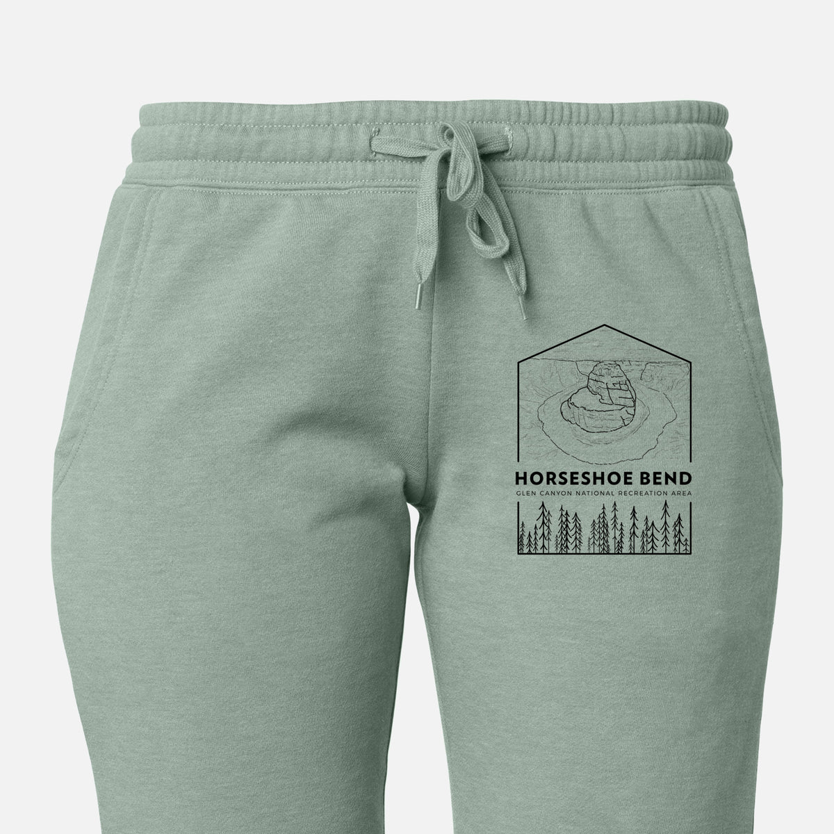 Front of sage green Cali Wave sweatpants, printed with a black line art badge of Horseshoe Bend above pine trees, with the words Horseshoe Bend on the leg.