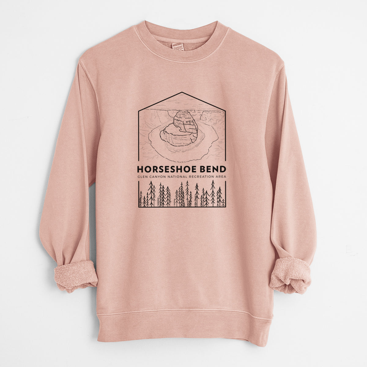 Dusty pink pigment dyed crewneck sweatshirt laid flat with the sleeves rolled, printed with a black line art badge of Horseshoe Bend above pine trees, with the words Horseshoe Bend.