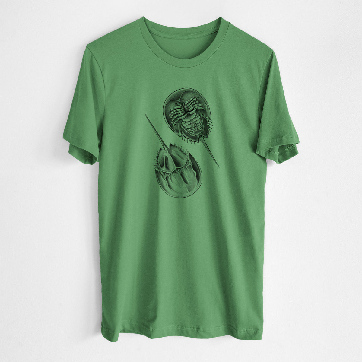Leaf green lightweight cotton t-shirt laid flat, printed with a detailed black ink illustration of two horseshoe crabs.