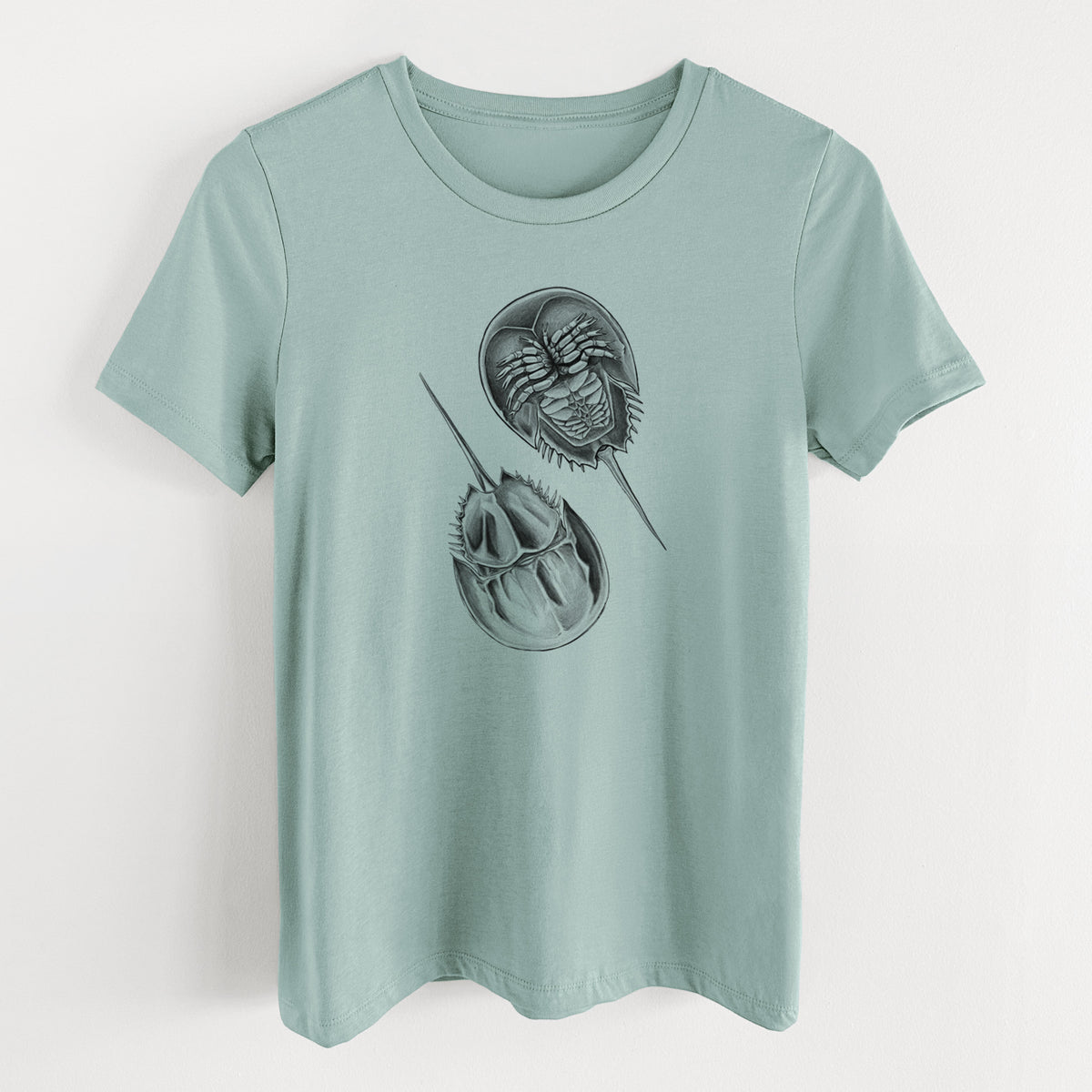 Dusty blue women's relaxed fit cotton t-shirt laid flat, printed with a detailed black ink illustration of two horseshoe crabs.