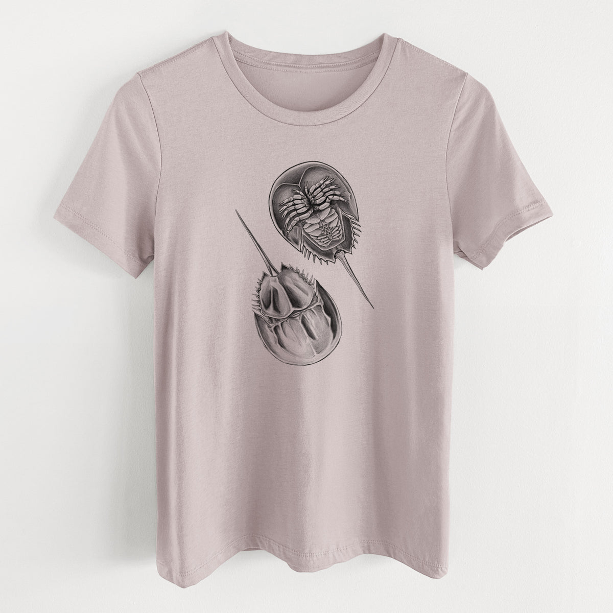Pink gravel women's relaxed fit cotton t-shirt laid flat, printed with a detailed black ink illustration of two horseshoe crabs.
