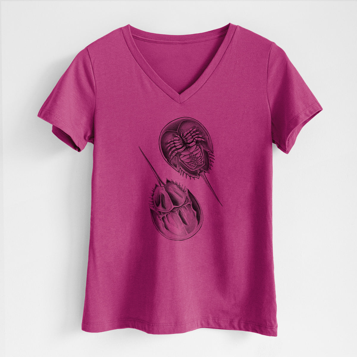 Berry pink women's relaxed fit cotton V-neck t-shirt laid flat, printed with a detailed black ink illustration of two horseshoe crabs.