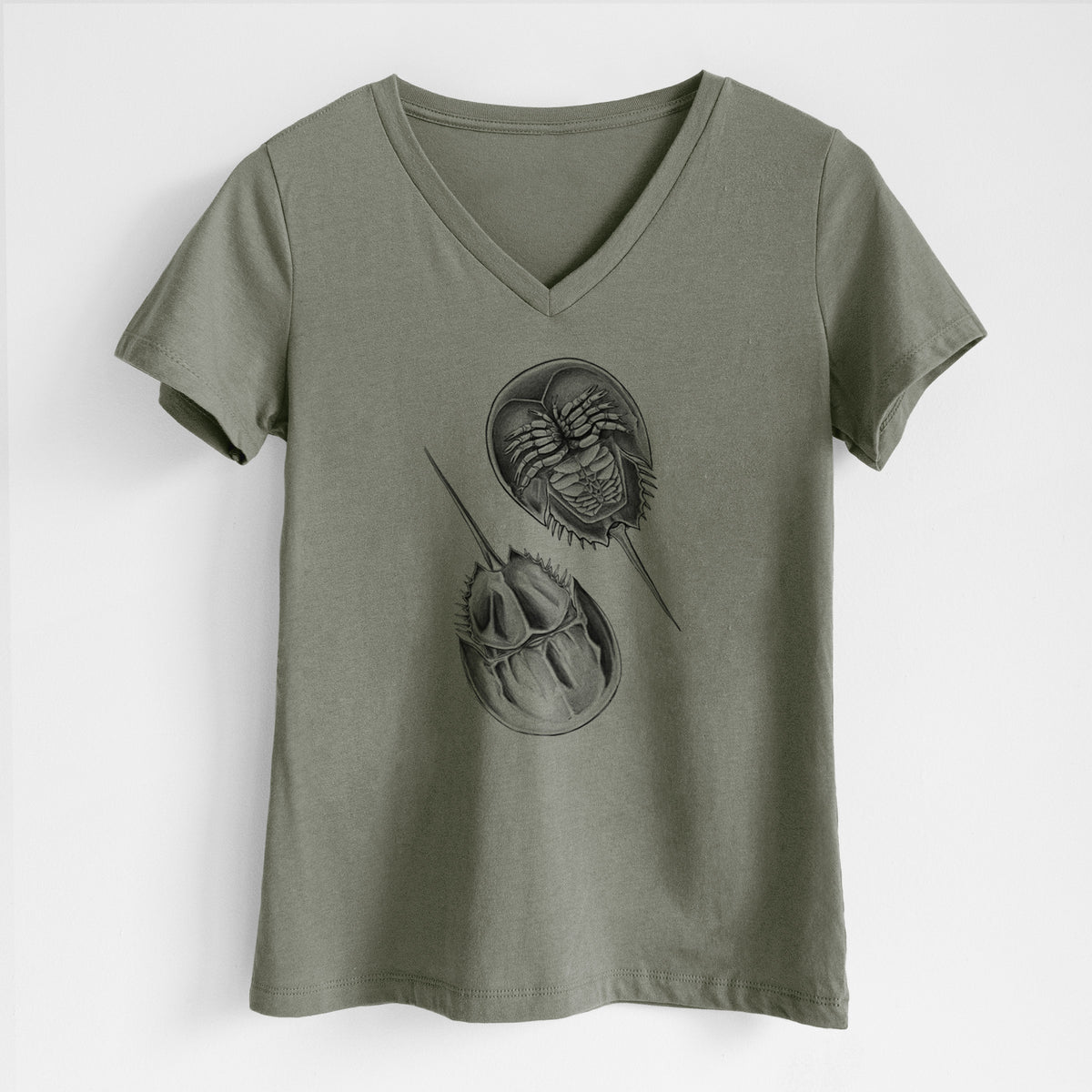 Military green women's relaxed fit cotton V-neck t-shirt laid flat, printed with a detailed black ink illustration of two horseshoe crabs.