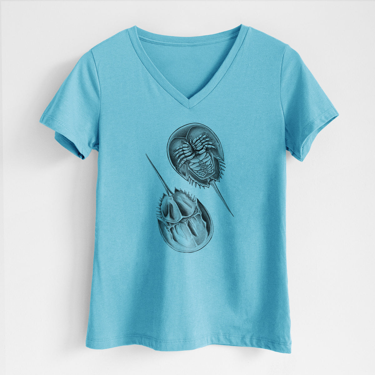 Turquoise women's relaxed fit cotton V-neck t-shirt laid flat, printed with a detailed black ink illustration of two horseshoe crabs.