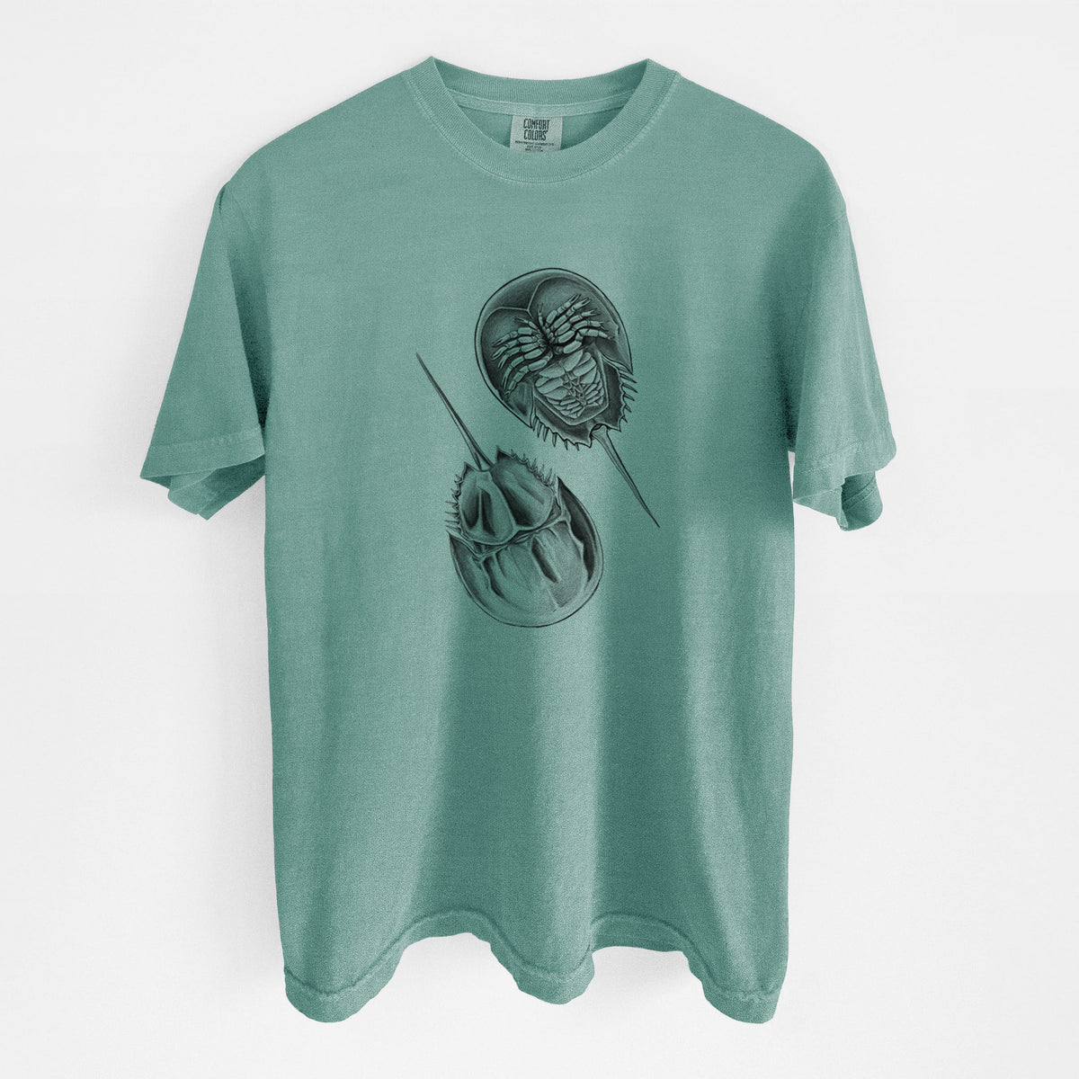 Reef green Comfort Colors t-shirt laid flat, printed with a detailed black ink illustration of two horseshoe crabs.
