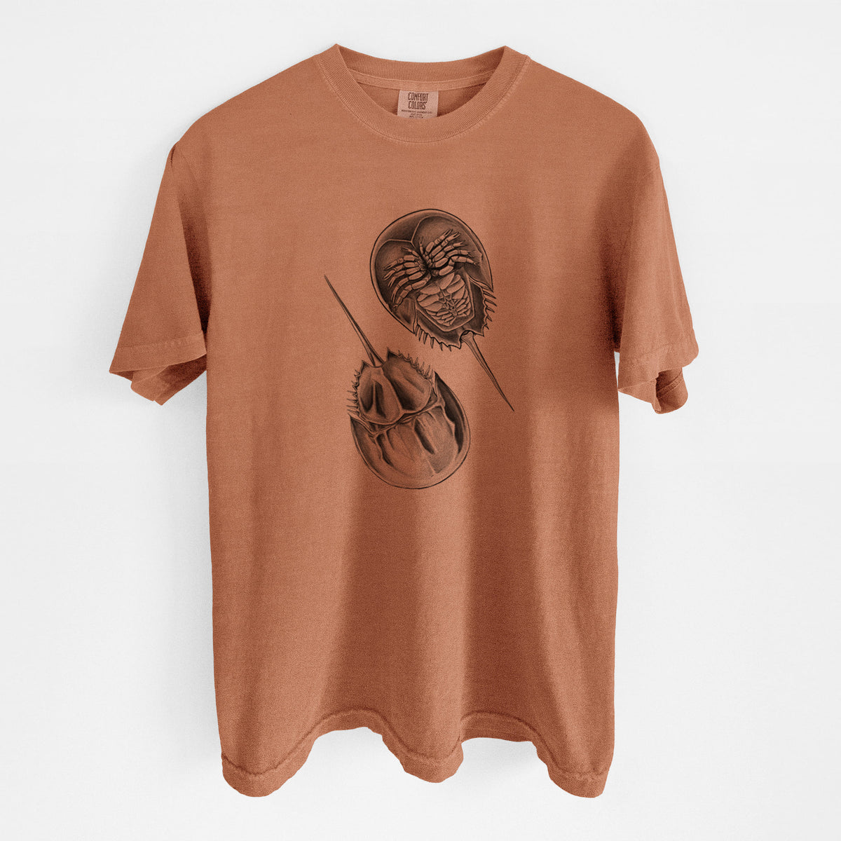 Yam burnt orange Comfort Colors t-shirt laid flat, printed with a detailed black ink illustration of two horseshoe crabs.