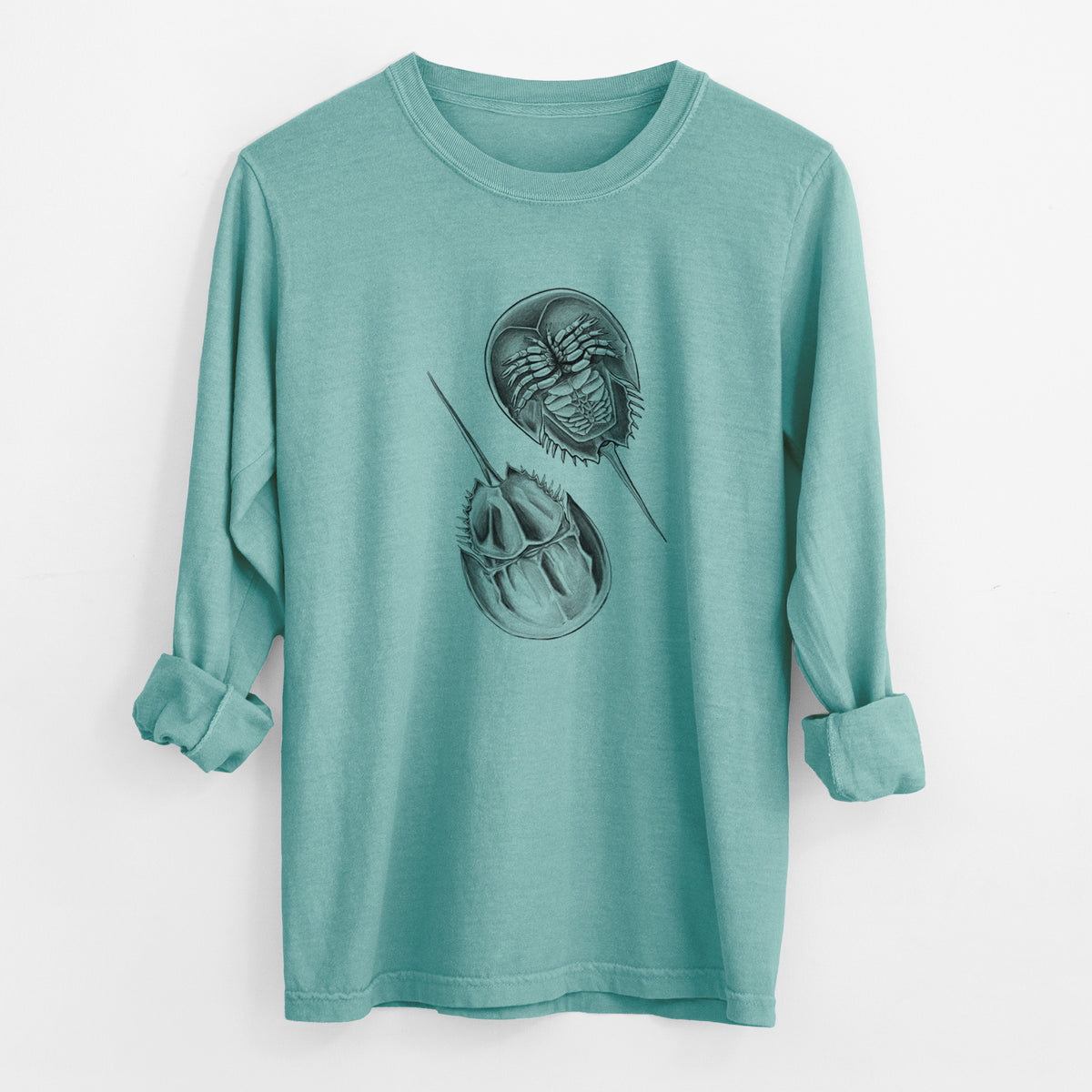 Reef green Comfort Colors long sleeve shirt laid flat with the cuffs rolled, printed with a detailed black ink illustration of two horseshoe crabs.