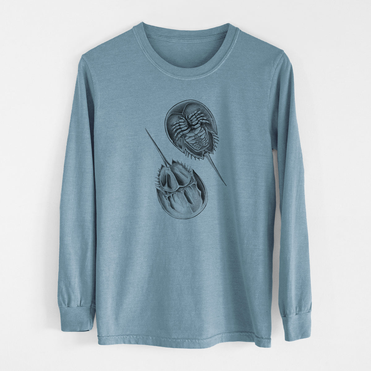 Steel blue Comfort Colors long sleeve shirt laid flat, printed with a detailed black ink illustration of two horseshoe crabs.