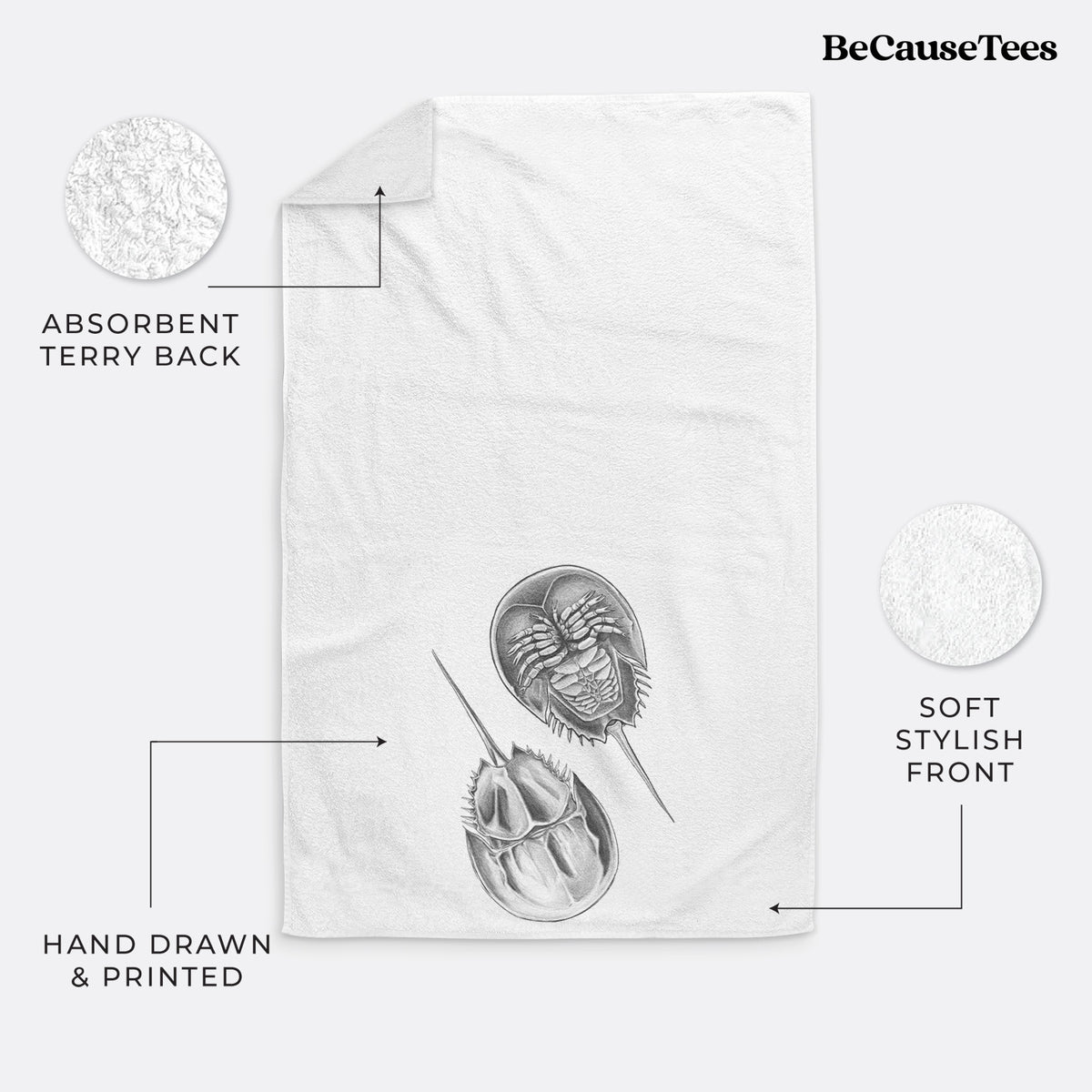 White hand towel printed with a detailed black ink illustration of two horseshoe crabs.