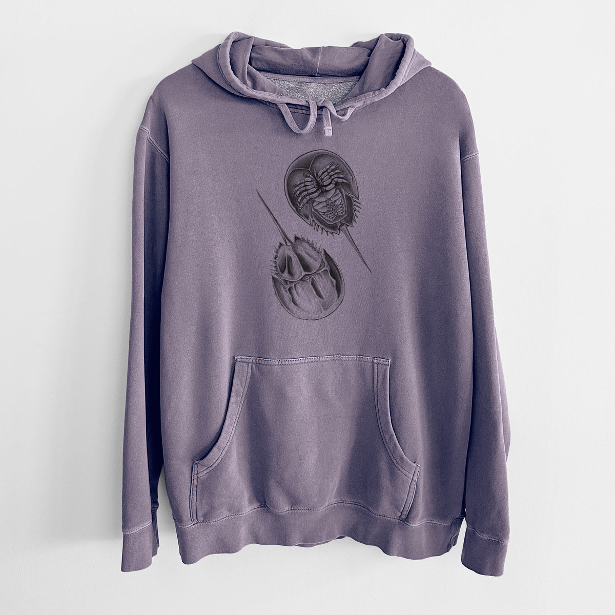 Plum purple pigment dyed hoodie laid flat, printed with a detailed black ink illustration of two horseshoe crabs.