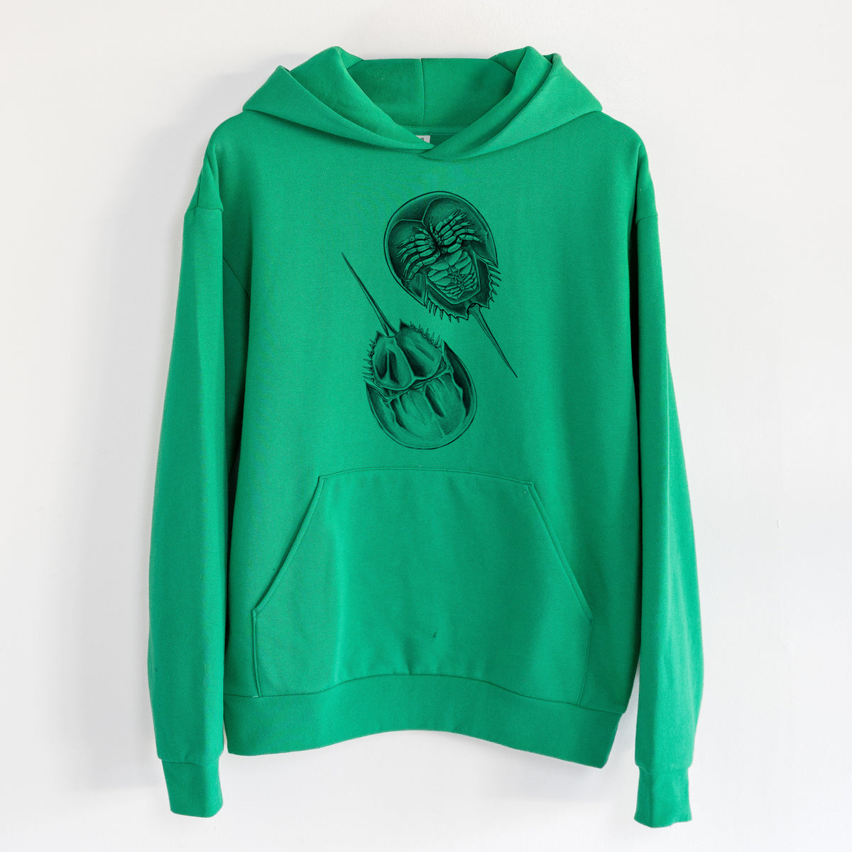 Atlantic Horseshoe Crab - Limulidae polyphemus - Statement Midweight Hoodie in Kelly Green, hanging on a white wall, with a front kangaroo pocket and no drawcords.