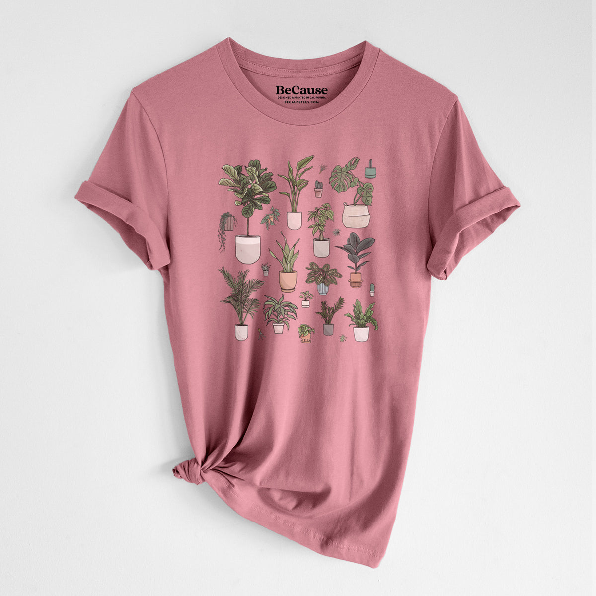 Mauve pink lightweight cotton t-shirt laid flat with the sleeves rolled, printed with a full-color collection of potted houseplants in different pots.
