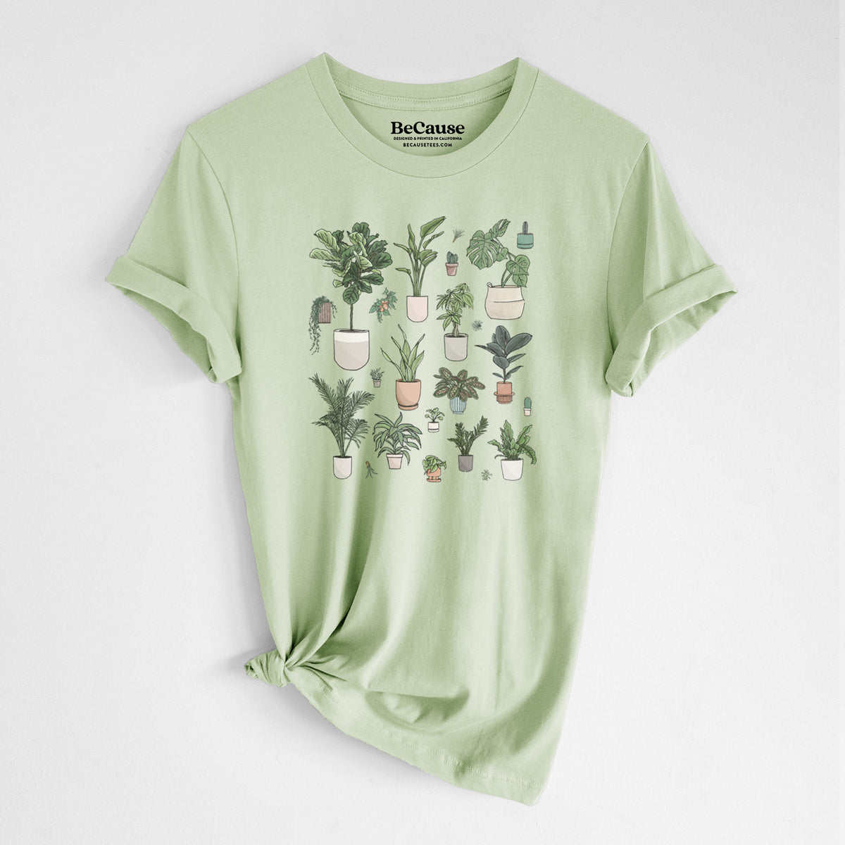 Spring green lightweight cotton t-shirt laid flat with the sleeves rolled, printed with a full-color collection of potted houseplants in different pots.