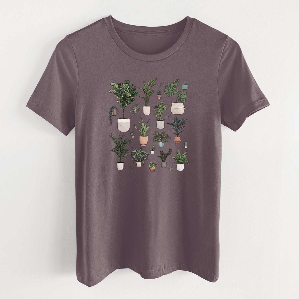 Purple storm women's relaxed fit cotton t-shirt laid flat, printed with a full-color collection of potted houseplants in different pots.