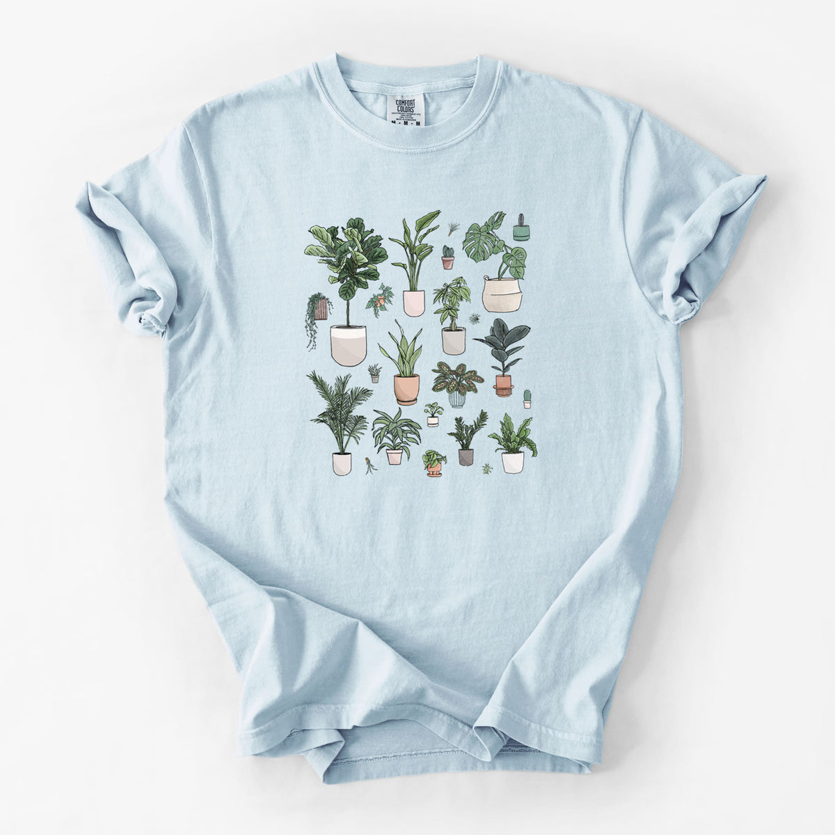 Chambray blue Comfort Colors t-shirt laid flat, printed with a full-color collection of potted houseplants in different pots.