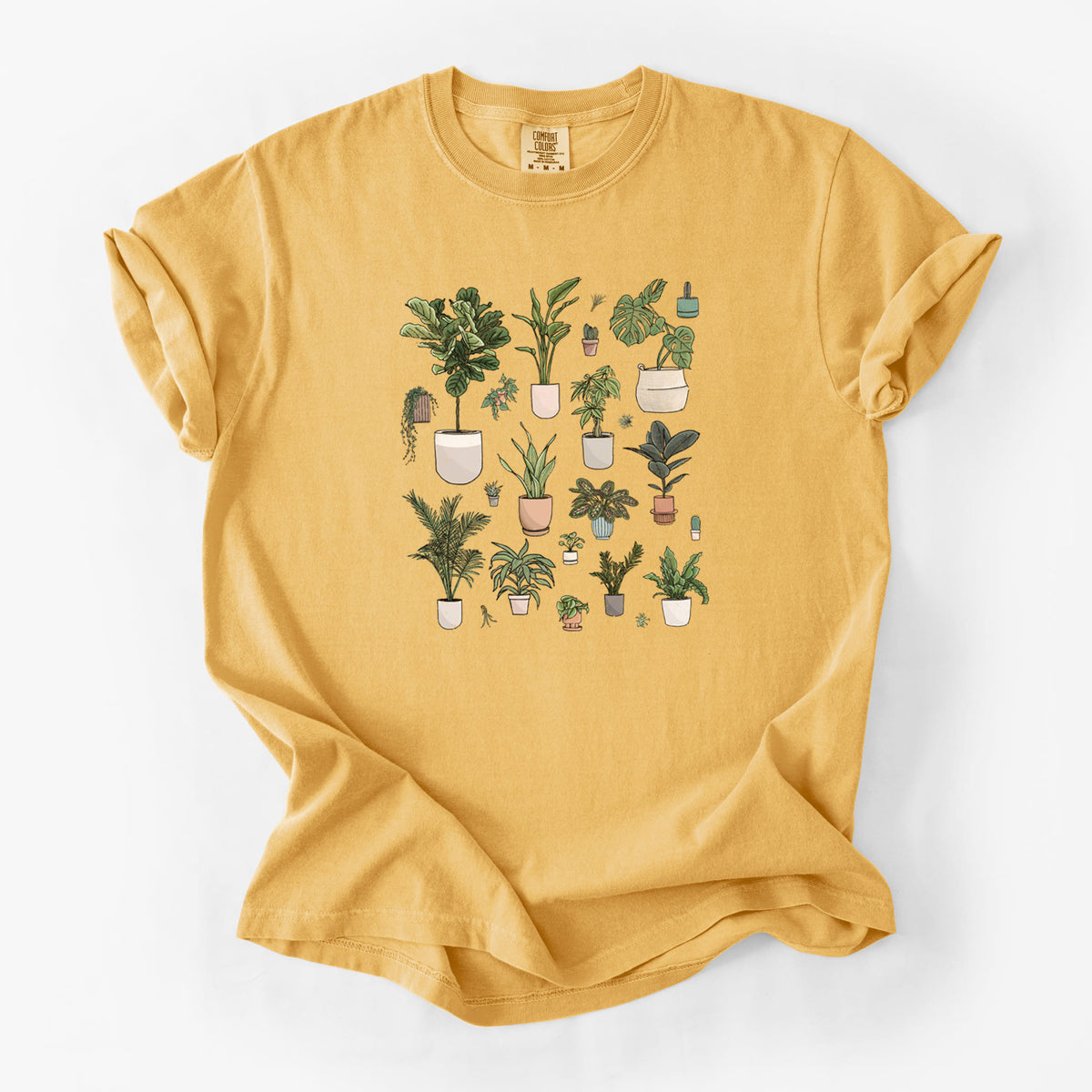 Golden wheat yellow Comfort Colors t-shirt laid flat, printed with a full-color collection of potted houseplants in different pots.