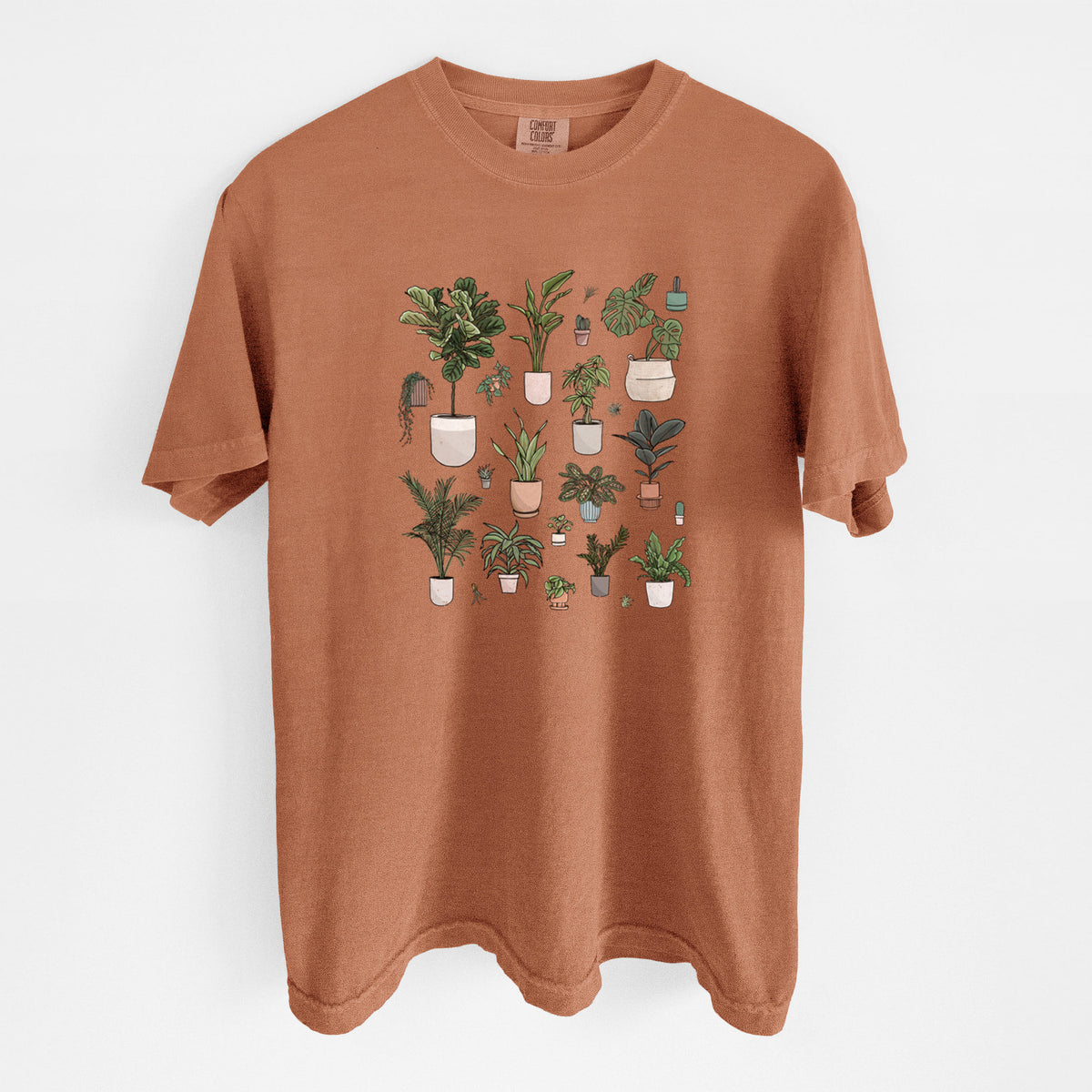 Yam burnt orange Comfort Colors t-shirt laid flat, printed with a full-color collection of potted houseplants in different pots.