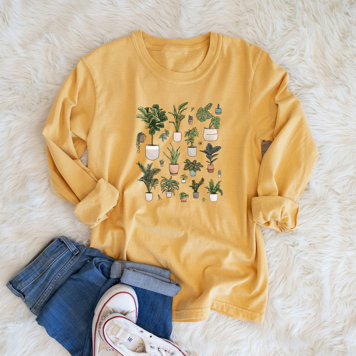 Golden wheat yellow Comfort Colors long sleeve shirt printed with a full-color collection of potted houseplants in different pots, shown in a lifestyle photo.