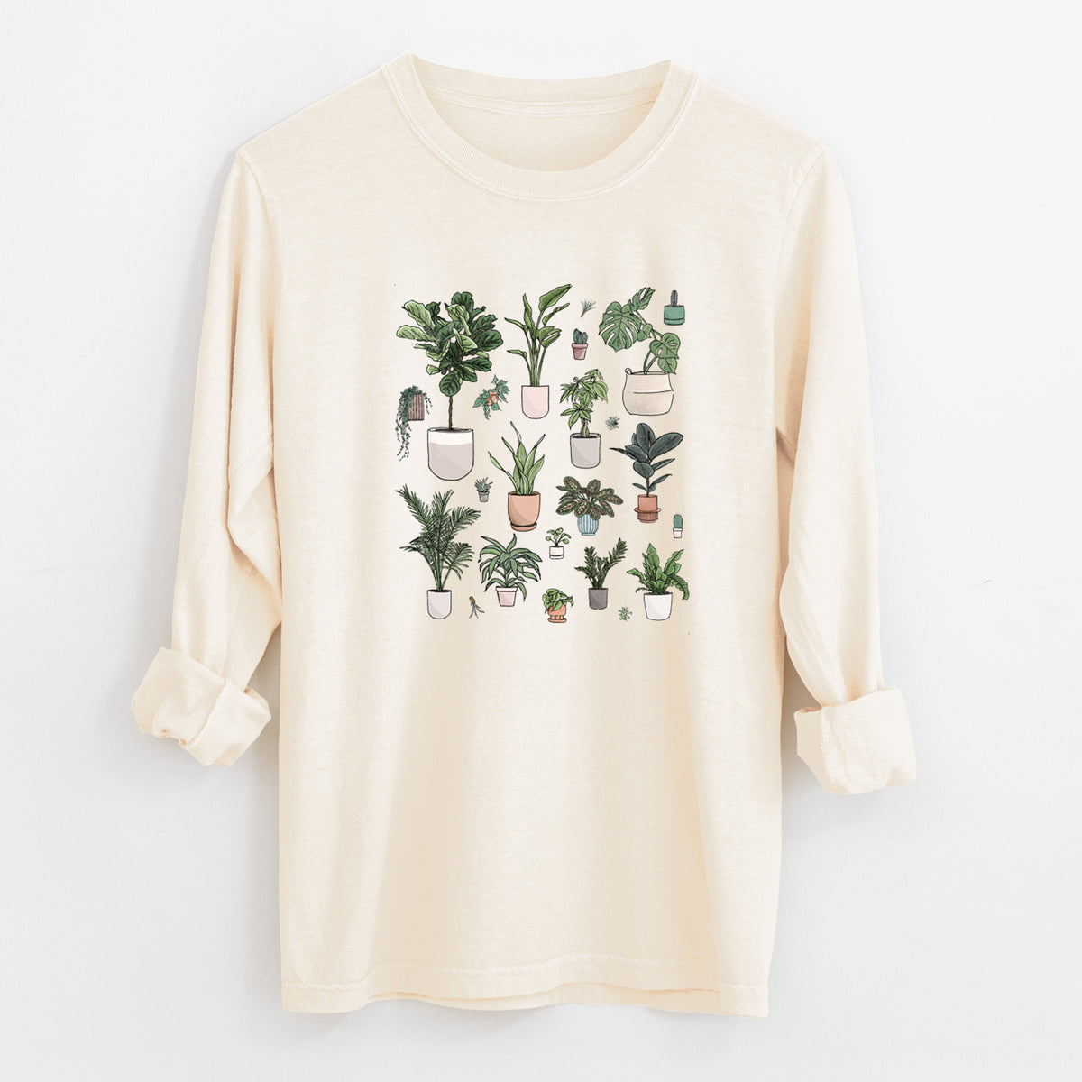 Ivory Comfort Colors long sleeve shirt laid flat with the cuffs rolled, printed with a full-color collection of potted houseplants in different pots.