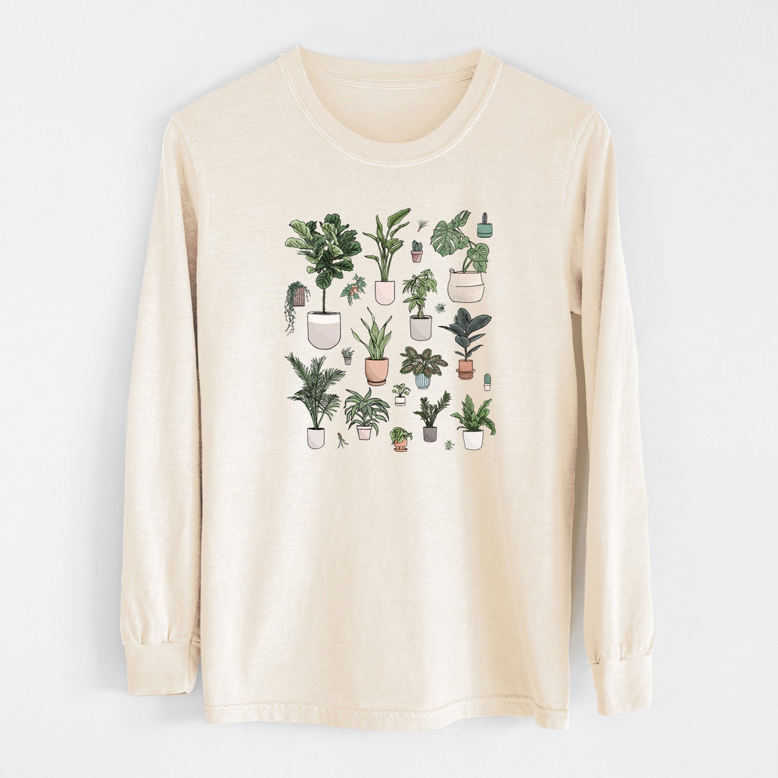 Ivory Comfort Colors long sleeve shirt laid flat, printed with a full-color collection of potted houseplants in different pots.