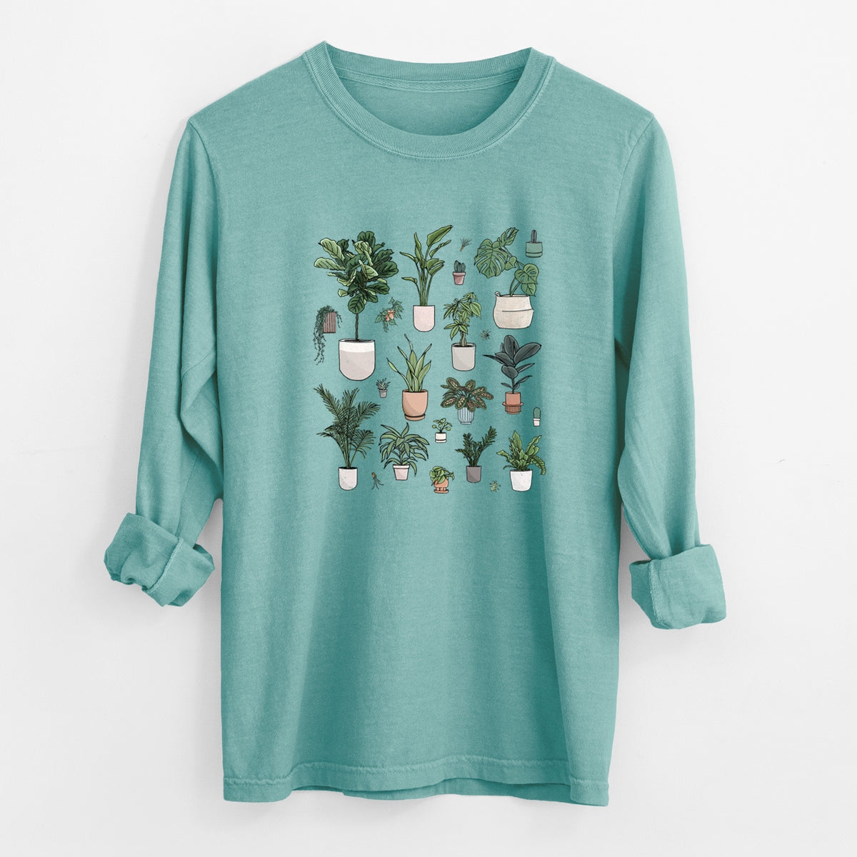 Reef green Comfort Colors long sleeve shirt laid flat with the cuffs rolled, printed with a full-color collection of potted houseplants in different pots.