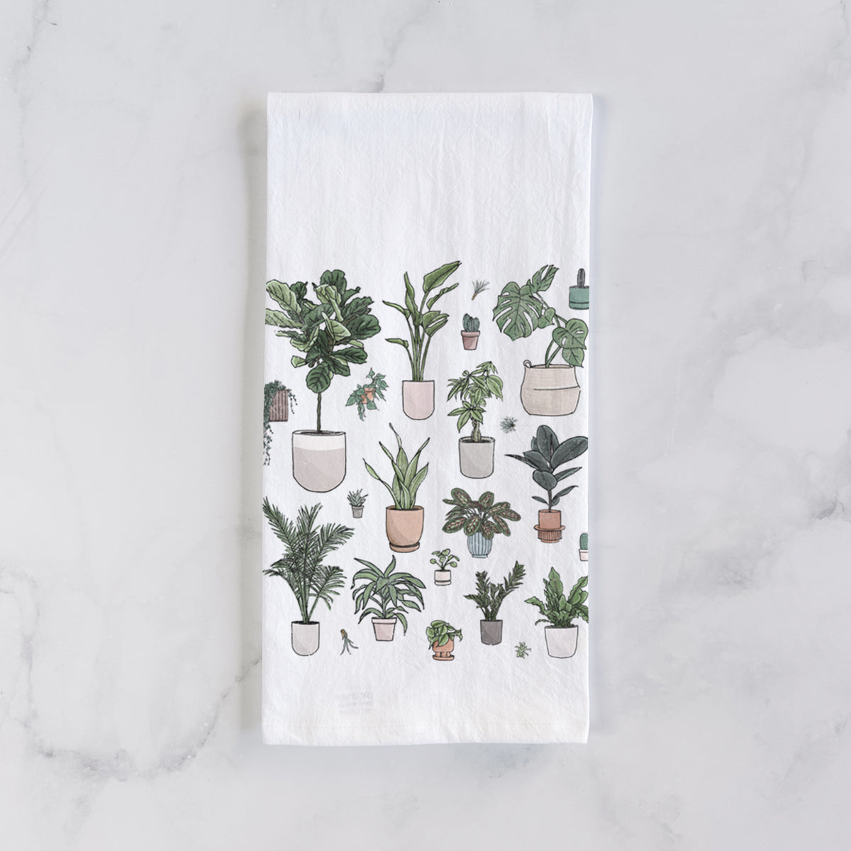 White cotton tea towel laid flat on marble, printed with a full-color collection of potted houseplants in different pots.