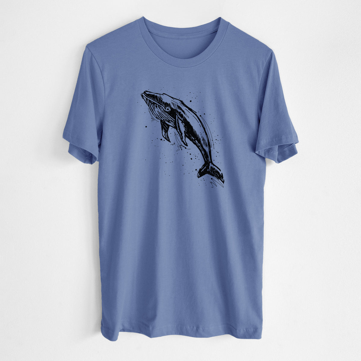 Blue bell lightweight cotton t-shirt laid flat, printed with a black ink illustration of a humpback whale diving, with ink splatters.