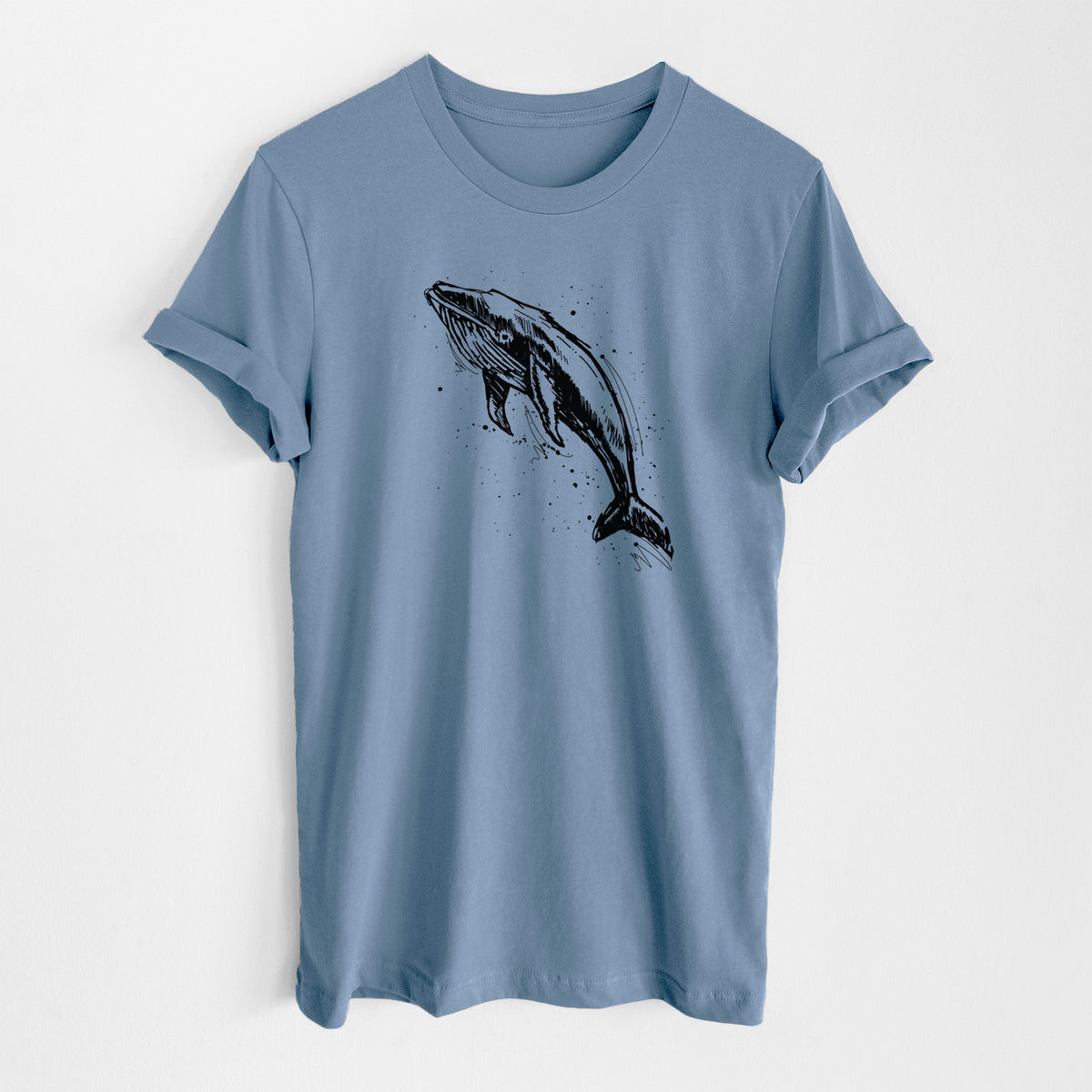 Steel blue lightweight cotton t-shirt laid flat, printed with a black ink illustration of a humpback whale diving, with ink splatters.
