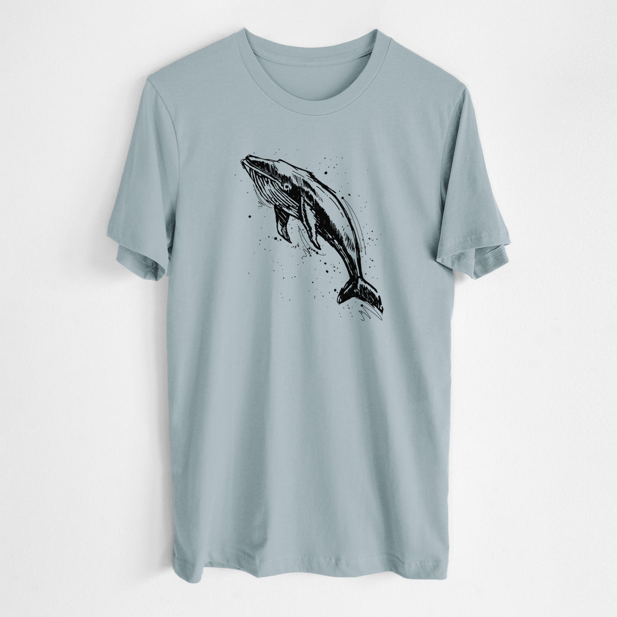 Vintage denim lightweight cotton t-shirt laid flat, printed with a black ink illustration of a humpback whale diving, with ink splatters.