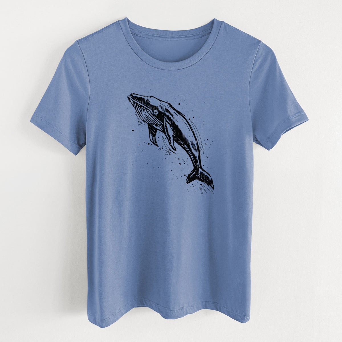 Blue bell women's relaxed fit cotton t-shirt laid flat, printed with a black ink illustration of a humpback whale diving, with ink splatters.