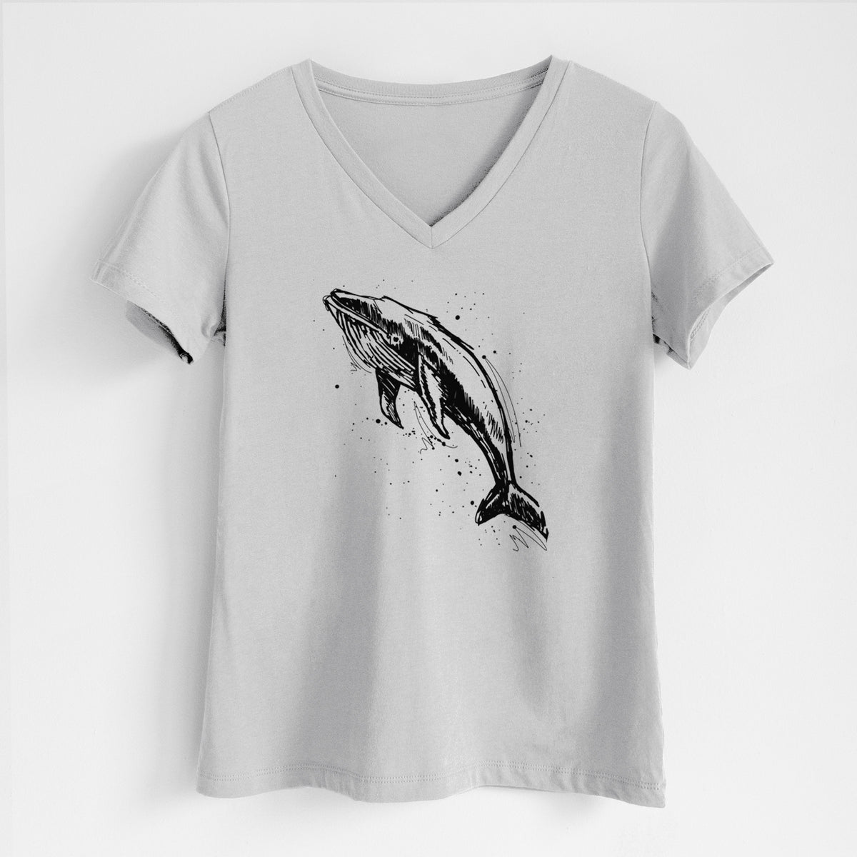 Lunar grey women's relaxed fit cotton V-neck t-shirt laid flat, printed with a black ink illustration of a humpback whale diving, with ink splatters.