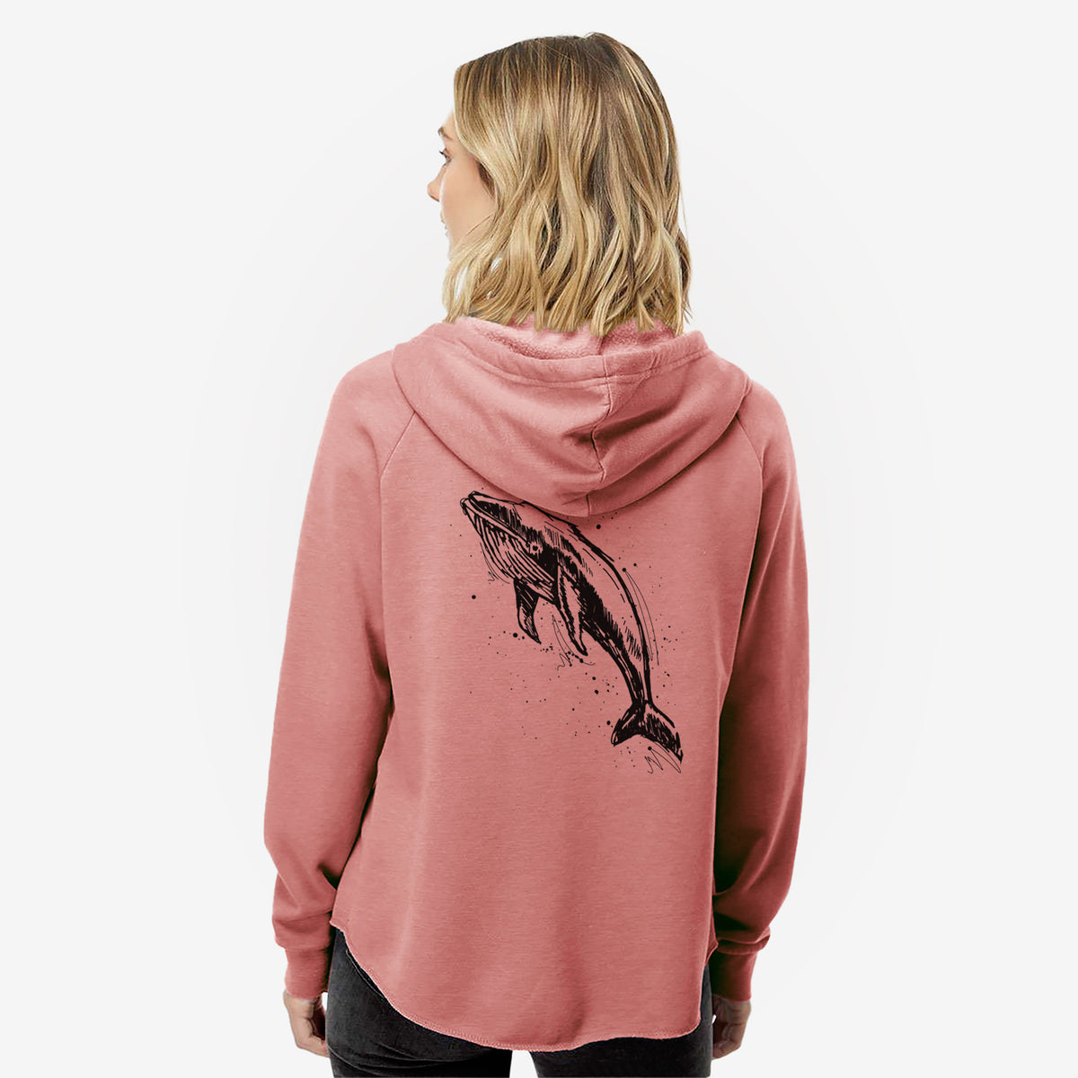 Woman wearing a dusty rose women's Cali Wave zip-up sweatshirt printed with a black ink illustration of a humpback whale diving, with ink splatters, seen from behind.