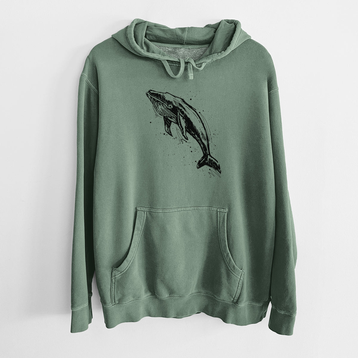 Alpine green pigment dyed hoodie laid flat, printed with a black ink illustration of a humpback whale diving, with ink splatters.
