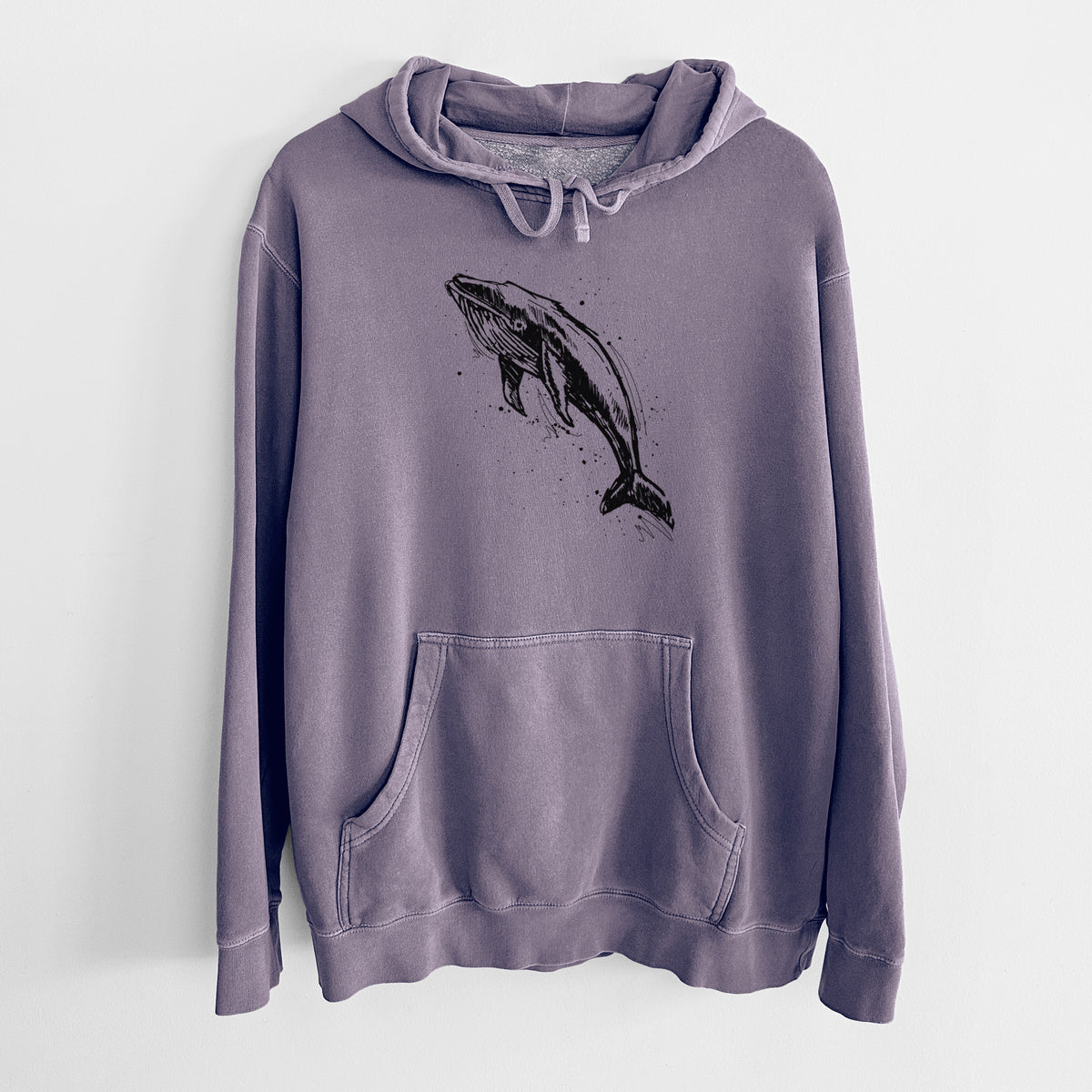 Plum purple pigment dyed hoodie laid flat, printed with a black ink illustration of a humpback whale diving, with ink splatters.