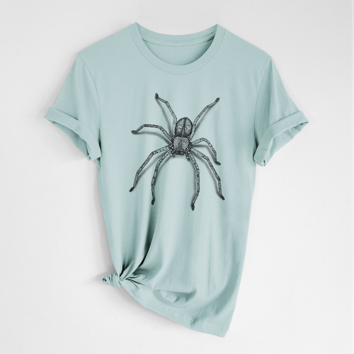 Dusty blue lightweight cotton t-shirt laid flat with the sleeves rolled, printed with a detailed black ink illustration of a huntsman spider with long legs spread.