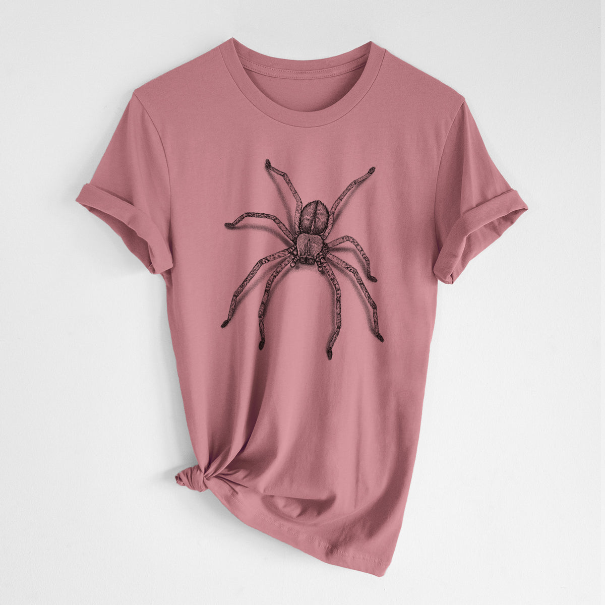 Mauve pink lightweight cotton t-shirt laid flat with the sleeves rolled, printed with a detailed black ink illustration of a huntsman spider with long legs spread.