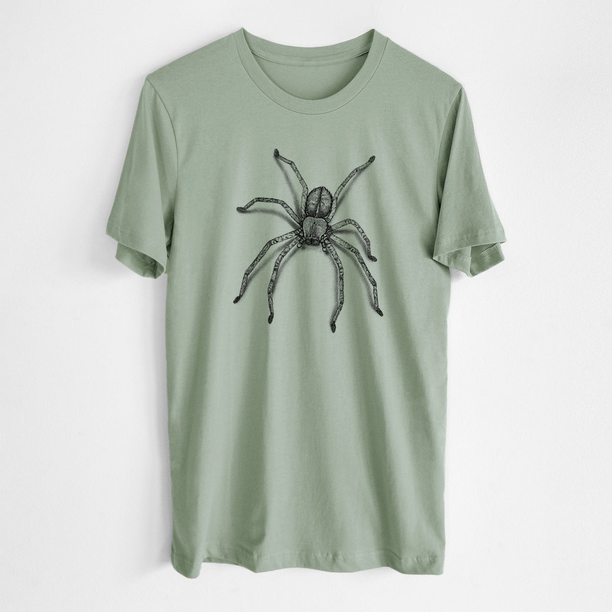 Sage green lightweight cotton t-shirt laid flat, printed with a detailed black ink illustration of a huntsman spider with long legs spread.