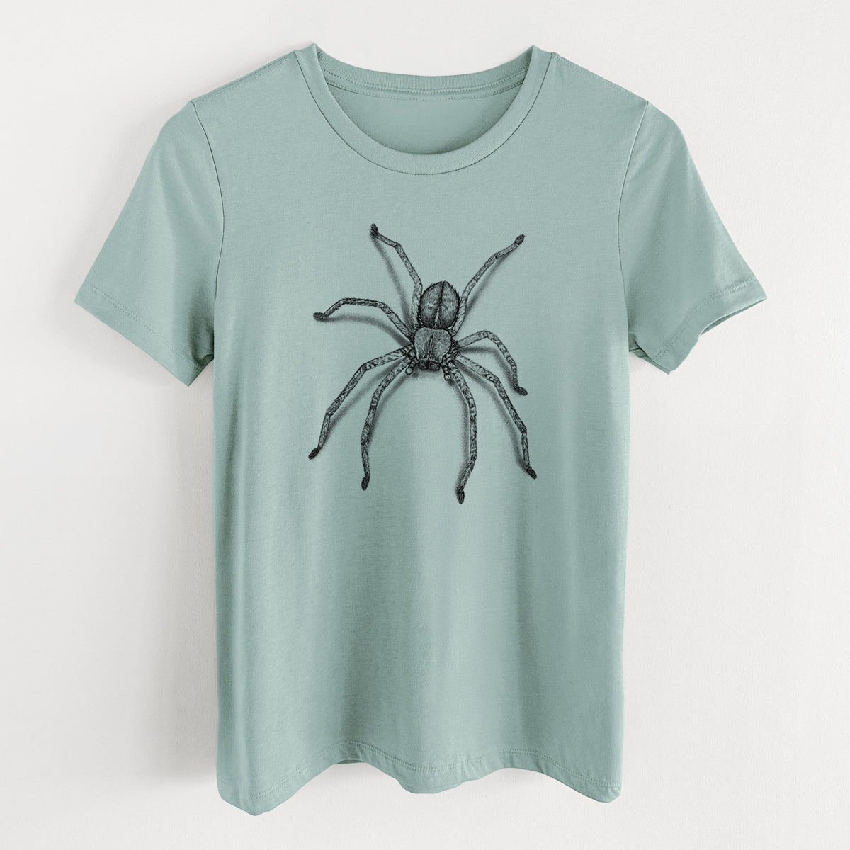 Dusty blue women's relaxed fit cotton t-shirt laid flat, printed with a detailed black ink illustration of a huntsman spider with long legs spread.