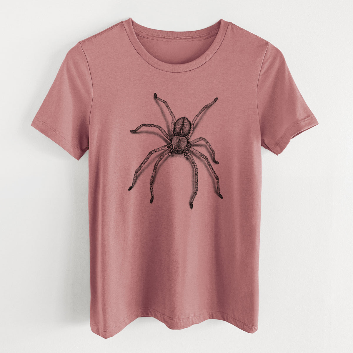 Mauve pink women's relaxed fit cotton t-shirt laid flat, printed with a detailed black ink illustration of a huntsman spider with long legs spread.